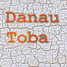 danau toba is written in red and green on a cracked wall .