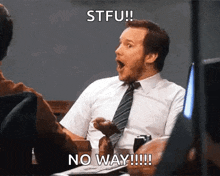a man in a suit and tie is sitting at a table with his mouth open and a caption that says stfu no way !!!