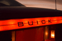 a close up of a buick car 's tail light with the word buick written on it