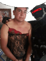 a man in a black lace top stands next to a man in a black mask