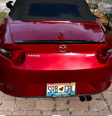 a red car with a license plate that says srb grl on it