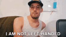 a man wearing glasses and a hat says i am not left handed