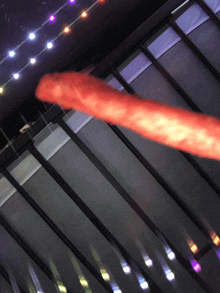 a long red object is hanging from a railing