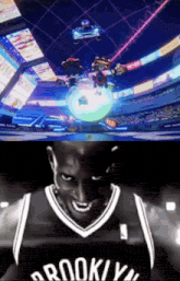 a brooklyn nets basketball player is smiling in front of a video game