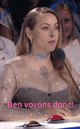 a woman is sitting in front of a microphone and the words ben voyons donc are on the bottom