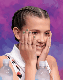 a girl with green nail polish and rings on her fingers