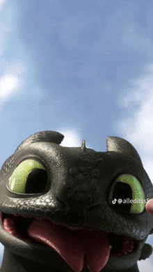 toothless from how to train your dragon is smiling with his tongue hanging out