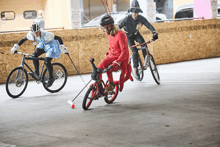 a man in a fireman costume is riding a bike next to two other people on bikes
