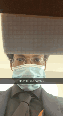 a man wearing glasses and a face mask has a note on his head that says " don 't let me catch u "