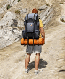 a man with a large backpack is walking down a dirt path