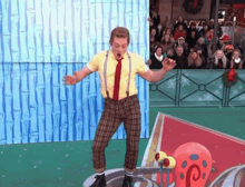 a man dressed as spongebob is dancing in front of a crowd