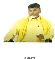 a man in a yellow shirt and yellow scarf is sitting in a chair and making a funny face .