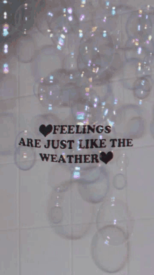 a sign that says feelings are just like the weather surrounded by soap bubbles