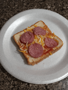 a slice of bread with sausage and cheese on it