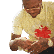 a man wearing a yellow shirt with a red chilli pepper on it