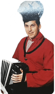 a man in a red jacket is holding an accordion and wearing a blue hat