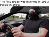 a man wearing a ski mask is driving a car