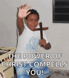 a boy holding a cross with the words " the power of christ compells you "