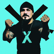 a man wearing a black shirt with a blue x on it