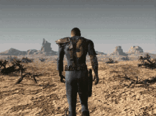 a man in a vault suit with the number 9 on the back walks through a desert