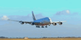 an emirates airplane is taking off from an airport