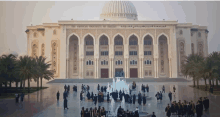 a group of people are standing in front of a large building that says the american university of dubai