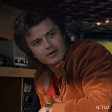a close up of a man 's face with the netflix logo behind him