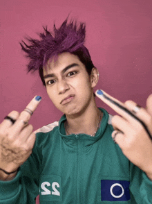 a man with purple hair and the number 35 on his jacket giving the middle finger