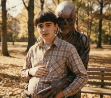 a man in a plaid shirt holds his pregnant belly while standing next to a monster