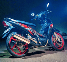 a black and red honda supra x motorcycle is parked on the street