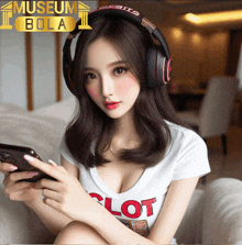 a woman wearing headphones is sitting on a couch with a museum bola logo behind her