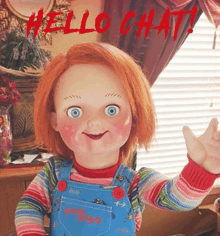 a chucky doll is sitting in front of a window waving .