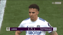 a soccer player in a white jersey with sbotop on the front