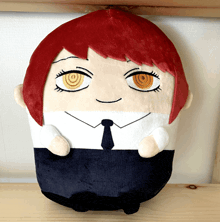 a stuffed toy of a man with red hair and yellow eyes