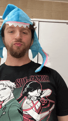 a man wearing a shark hat and a shirt that says sixty-nin