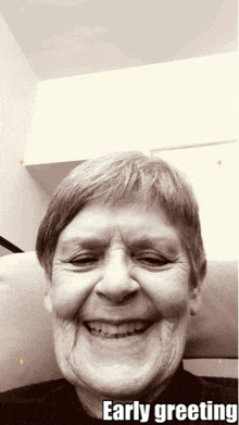 a black and white photo of an elderly woman with the words early greeting on the bottom