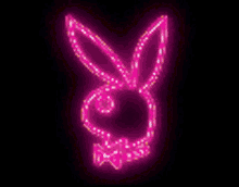 a pink playboy bunny is glowing in the dark on a black background