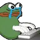 a green frog is crying while typing on a computer keyboard .