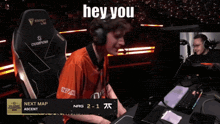 a man wearing headphones is smiling in front of a screen that says next map on it