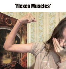 a woman flexes her muscles in front of a painting that says ' flexes muscles '