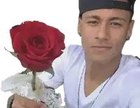 a man in a white shirt holds a red rose in his hand