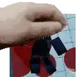 a person 's hand is holding a toy robot in their hand