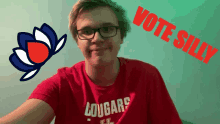 a young man wearing glasses and a red shirt that says cougars