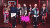 a group of women are singing in front of an open sign