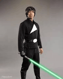 a man dressed as luke skywalker is holding a green lightsaber .