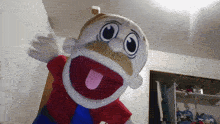 a puppet with a mustache and a red shirt