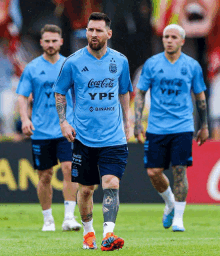 a soccer player wearing a blue coca cola ypf shirt