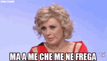 a woman in a red dress is saying " ma a me che me ne frega " .