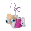 a stuffed animal with big eyes is hanging from a key chain .
