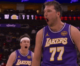 a basketball player wearing a lakers jersey stands with his mouth open